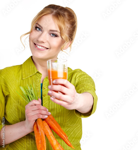 Photo: A young woman with juice of carrots A young woman with juice of carrots