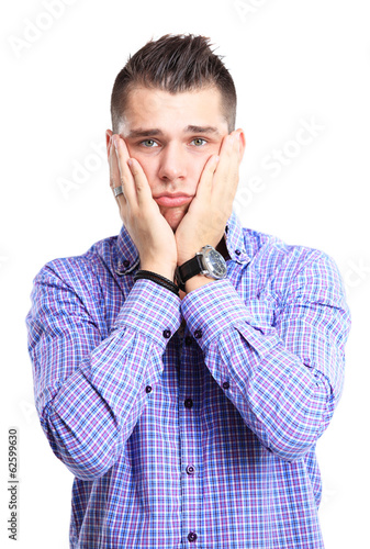 Photo: Portrait of young man with shocked facial expression Portrait of young man with shocked facial expression