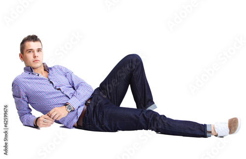 Photo: Flirtatious man sitting on the floor Flirtatious man sitting on the floor