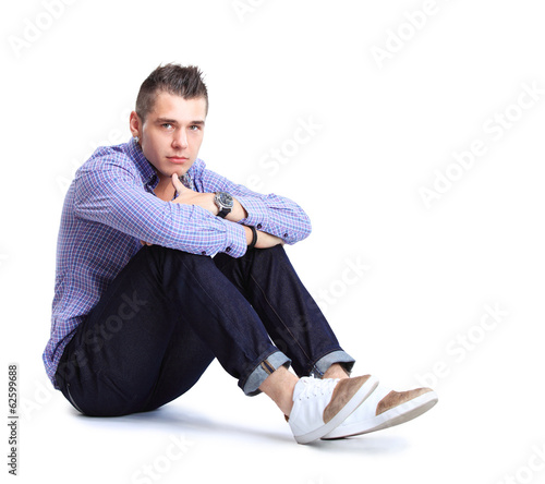 Photo: Flirtatious man sitting on the floor Flirtatious man sitting on the floor