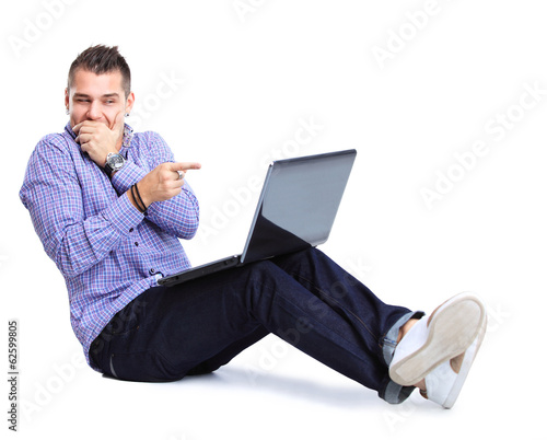 Photo: happy man working on laptop in casuals. Concept communication. happy man working on laptop in casuals. Concept communication.