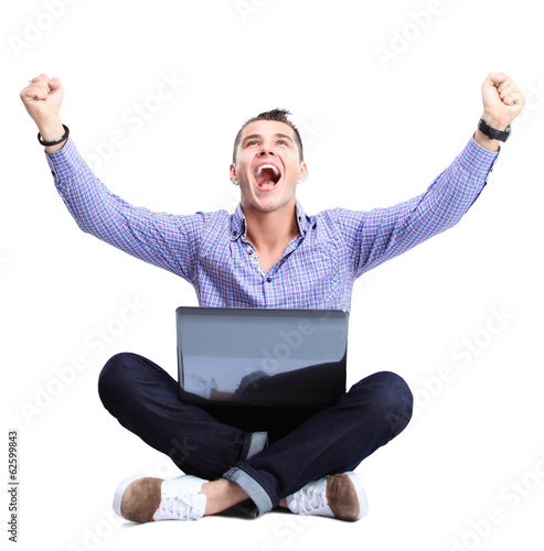 Photo: Business man celebrating his success with a computer laptop Business man celebrating his success with a computer laptop