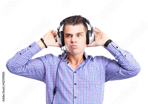 Photo: Attractive young man wearing headphones on white background Attractive young man wearing headphones on white background