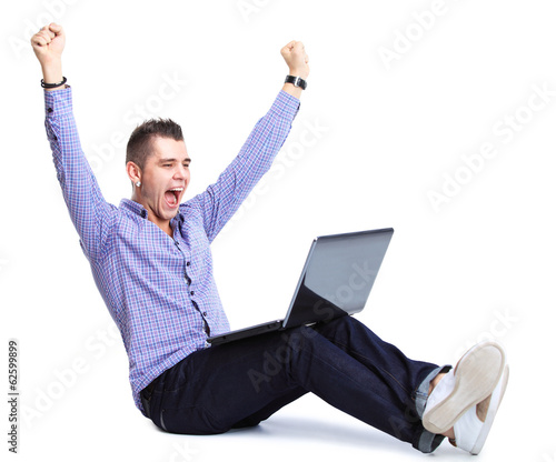 Photo: Business man celebrating his success with a computer laptop Business man celebrating his success with a computer laptop
