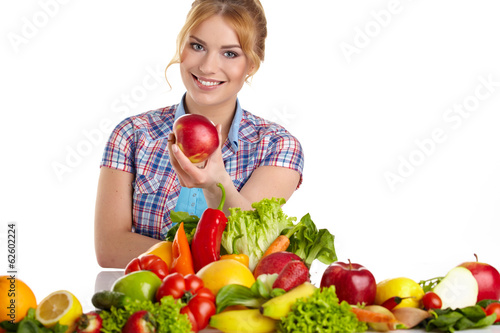 Photo: woman eating apple with lot of fruits and vegetables woman eating apple with lot of fruits and vegetables
