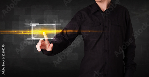 Photo: Tech business person touching button with orange light beams con Tech business person touching button with orange light beams con