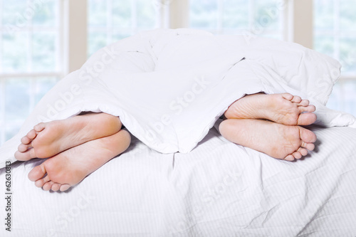 Photo: Two pair of feet on bed 1 Two pair of feet on bed 1