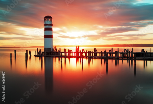 Fototapeta Beach sunrise with lighthouse