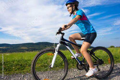 Photo: Healthy lifestyle - teenage girl biking Healthy lifestyle - teenage girl biking
