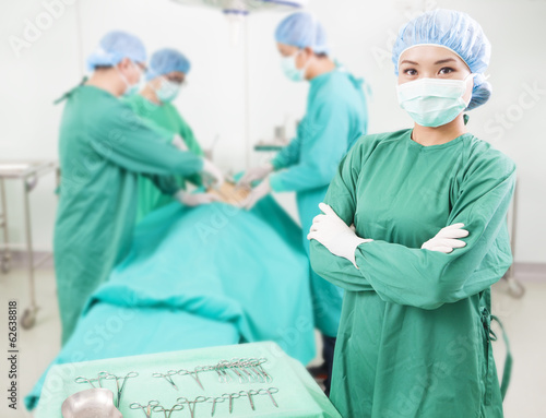 Photo: surgeon standing in front of a colleague in a surgical room surgeon standing in front of a colleague in a surgical room