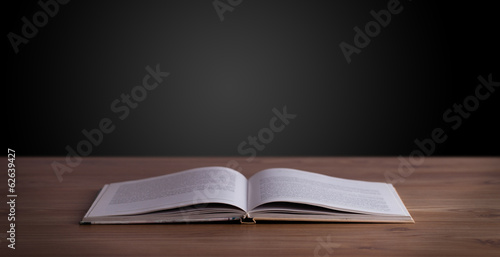 Photo: Open book on wooden deck Open book on wooden deck