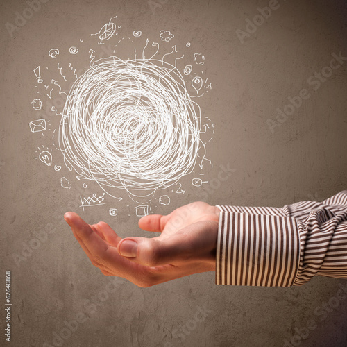 Photo: Chaos concept in the hand of a businessman Chaos concept in the hand of a businessman