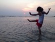 a little girl playing on the beach during sunset time a little girl playing on the beach during sunset time