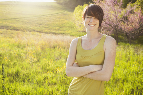Photo: Young Woman In Grassy Field In Spring. Young Woman In Grassy Field In Spring.