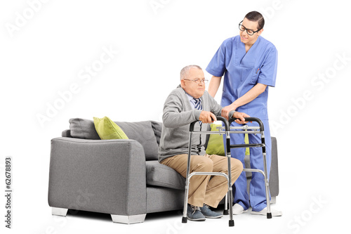 Photo: Male nurse helping an elderly gentleman to stand up Male nurse helping an elderly gentleman to stand up