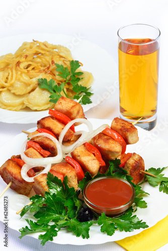 Photo: table with food of meat on skewer, dumplings and gass of juice. table with food of meat on skewer, dumplings and gass of juice.