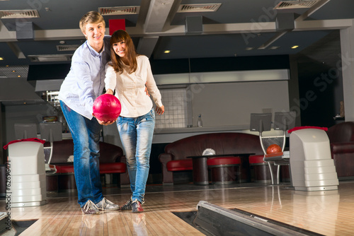 Photo: young couple plays bowling young couple plays bowling