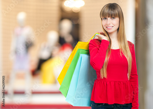 Photo: Smiling woman holding shopping bags Smiling woman holding shopping bags