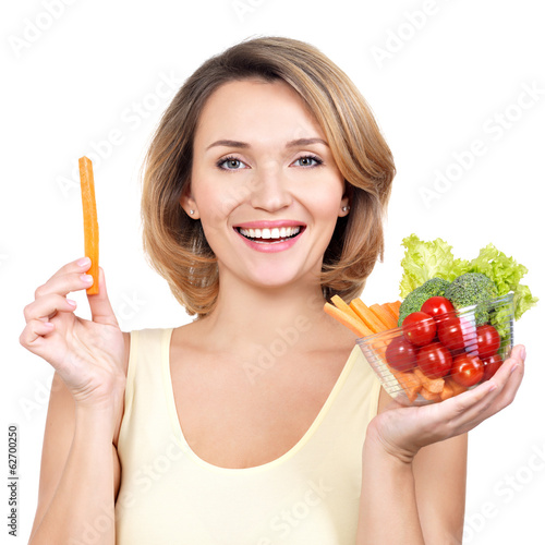 Photo: Beautiful young healthy woman with a plate of vegetables. Beautiful young healthy woman with a plate of vegetables.