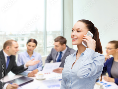 Photo: young smiling businesswoman with smartphone young smiling businesswoman with smartphone