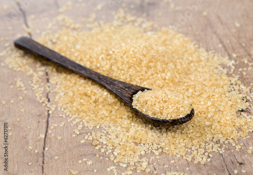Photo: brown cane sugar in a wooden spoon brown cane sugar in a wooden spoon
