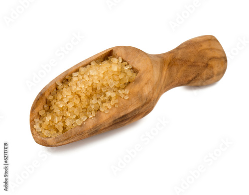Photo: brown cane sugar in a wooden spoon brown cane sugar in a wooden spoon