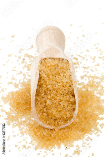 Photo: brown cane sugar in a wooden spoon brown cane sugar in a wooden spoon