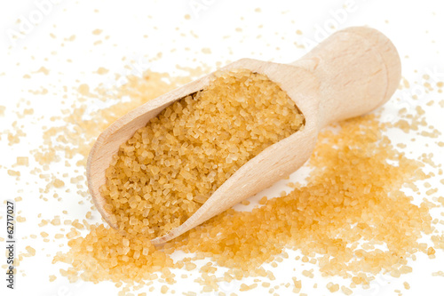 Photo: brown cane sugar in a wooden spoon brown cane sugar in a wooden spoon