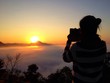 Woman silhouette take mobile photo of sunrise Woman silhouette take mobile photo of sunrise