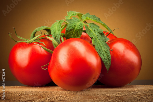 Photo: Organic tomato. Branch with leaves Organic tomato. Branch with leaves