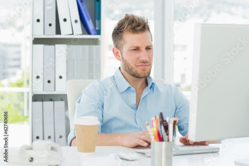 Photo: Handsome man working at his desk Handsome man working at his desk