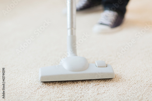 Photo: close up of male hoovering carpet close up of male hoovering carpet