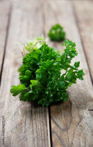 Photo: fresh green parsley on old rustick background fresh green parsley on old rustick background