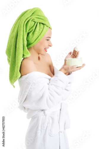 Photo: Woman in bathrobe with cream Woman in bathrobe with cream