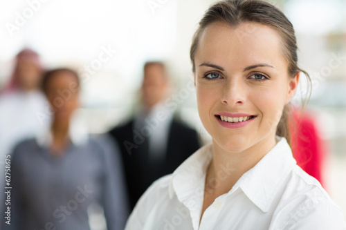 Photo: young businesswoman in front of colleagues young businesswoman in front of colleagues