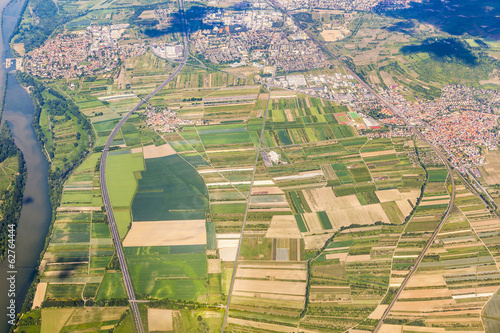 Photo: aerial of small village with fields and river rhine aerial of small village with fields and river rhine