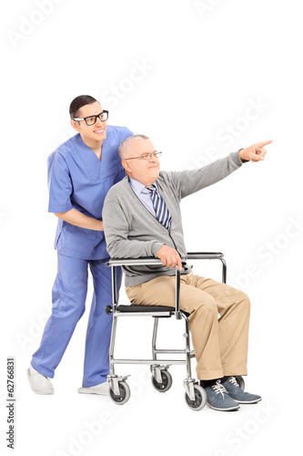 Photo: Senior in a wheelchair pointing with finger Senior in a wheelchair pointing with finger