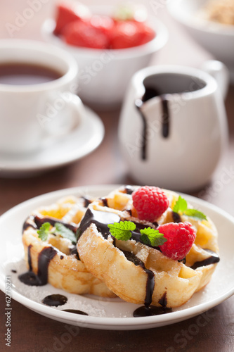 Photo: Belgian waffles with chocolate and raspberry for breakfast Belgian waffles with chocolate and raspberry for breakfast