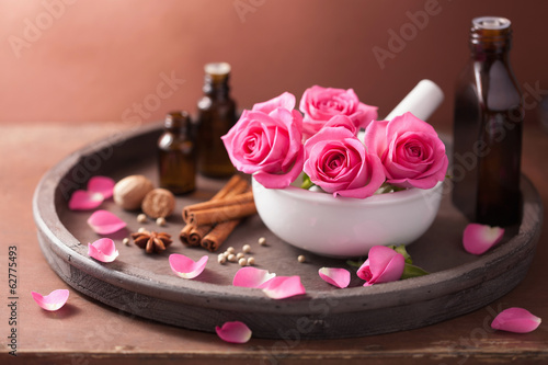 Photo: spa and aromatherapy set with rose flowers mortar and spices spa and aromatherapy set with rose flowers mortar and spices