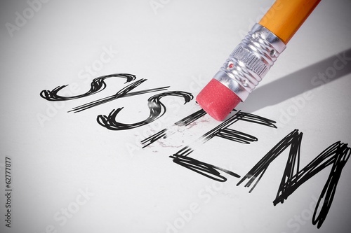 Photo: Pencil erasing the word System Pencil erasing the word System