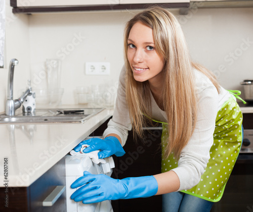 Photo: blonde woman cleaning washing machine blonde woman cleaning washing machine