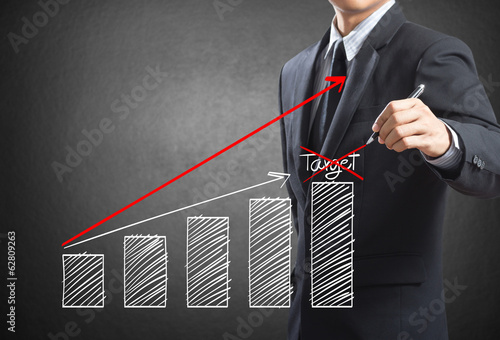 Photo: Business man drawing a growth chart, Success in business concept Business man drawing a growth chart, Success in business concept