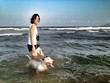 Asian woman and bull terrier on ter beach Asian woman and bull terrier on ter beach