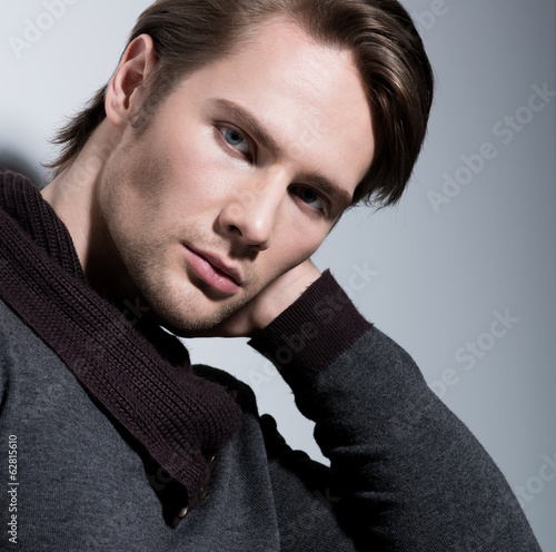 Photo: Portrait of sexy young man with hand near face. Portrait of sexy young man with hand near face.