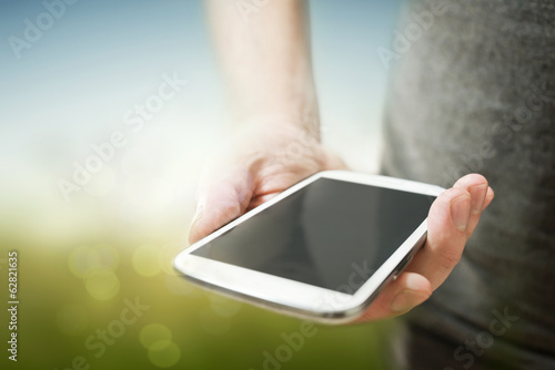 Photo: A Person Holding a Mobile Phone A Person Holding a Mobile Phone