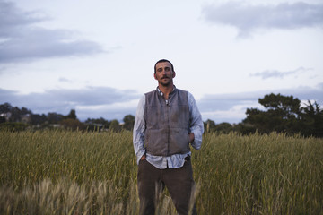 Photo: A man standing by a field of growing cereal crop, at the social care and work project, the Homeless Garden Project in Santa Cruz. A man standing by a field of growing cereal crop, at the social care and work project, the Homeless Garden Project in Santa Cruz.