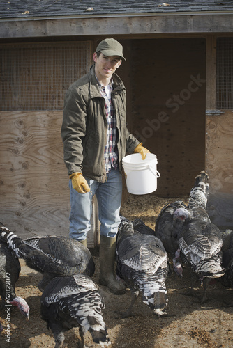 Photo: A small organic dairy farm with a mixed herd of cows and goats. Farmer working and tending to the animals. A small organic dairy farm with a mixed herd of cows and goats. Farmer working and tending to the animals.