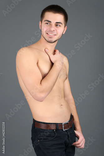 Photo: Handsome young man on gray background Handsome young man on gray background