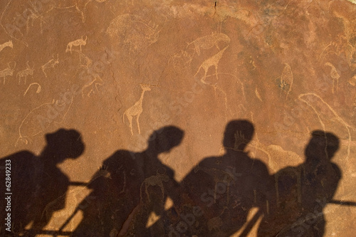Photo: The shadows of tourists at a viewing point, on the surface of the rock at Twyfelfontein World Heritage Site at Uibasen Conservancy, Damaraland, Namibia. The shadows of tourists at a viewing point, on the surface of the rock at Twyfelfontein World Heritage Site at Uibasen Conservancy, Damaraland, Namibia.