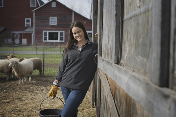 Photo: A small organic dairy farm with a mixed herd of cows and goats. Farmer working and tending to the animals. A small organic dairy farm with a mixed herd of cows and goats. Farmer working and tending to the animals.